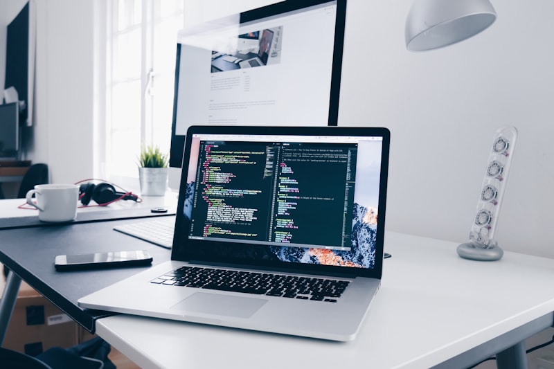 Kinetic web design workspace with multiple monitors showing dynamic layouts and code