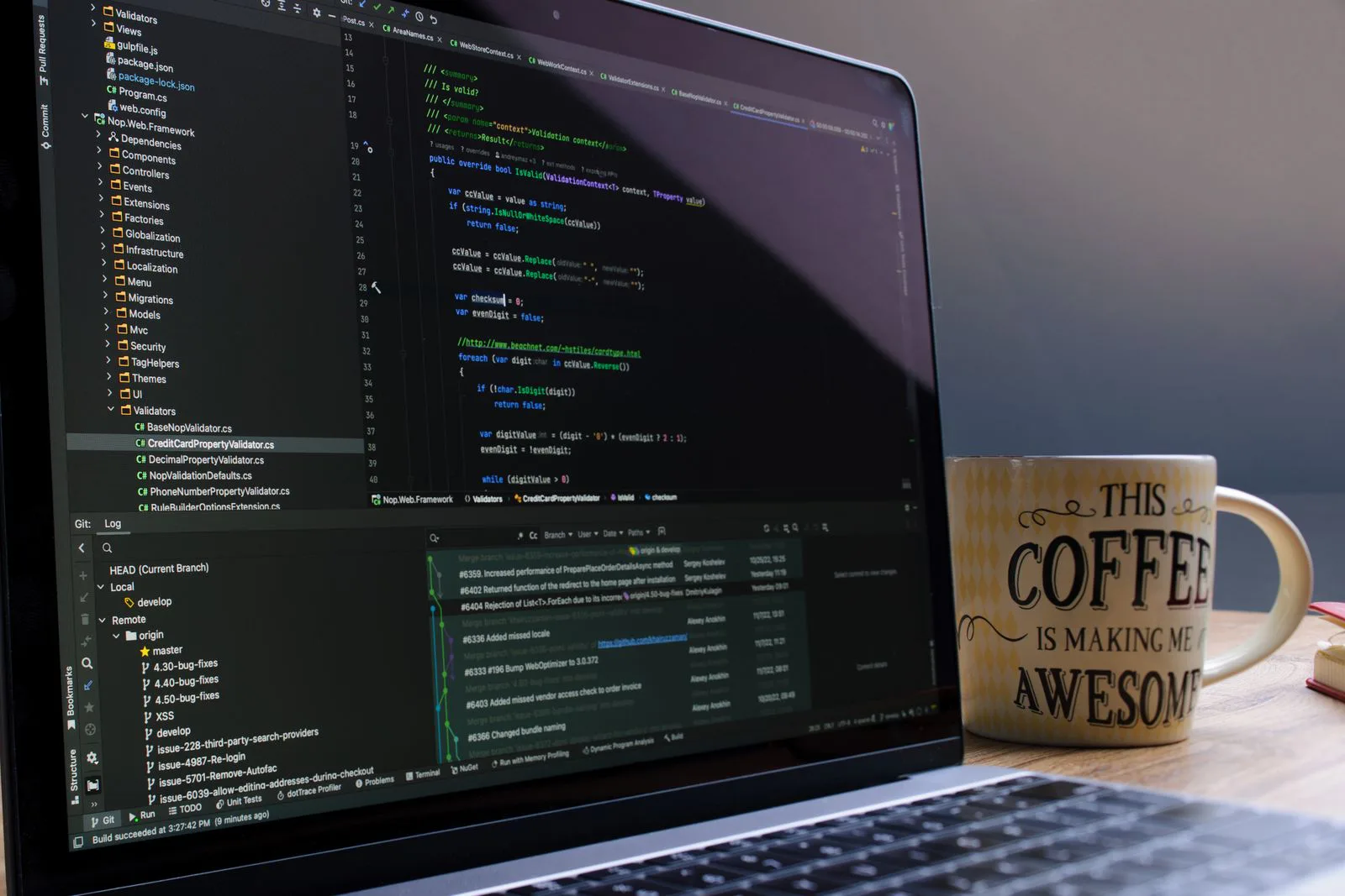 Laptop screen showing a code editor next to a coffee mug