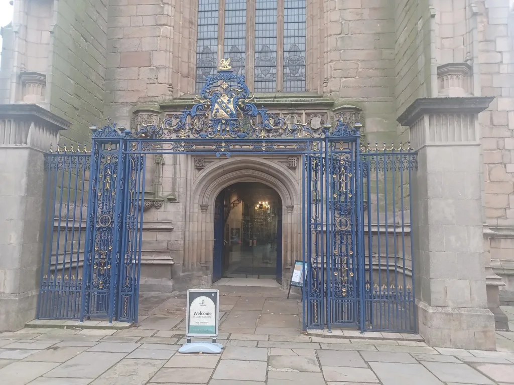 Ornate blue gates at the entrance to Derby Cathedral