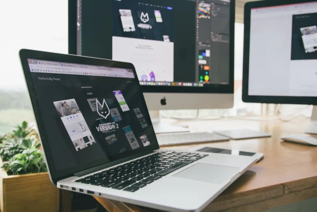Laptop showing brand design work on a desk
