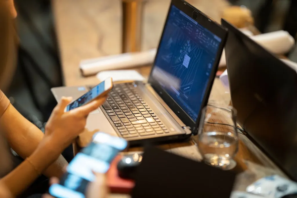Laptop and smartphone in use on a desk