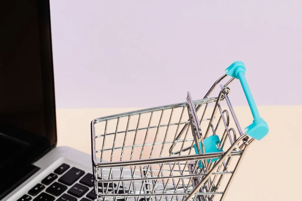 Miniature shopping cart on a laptop keyboard